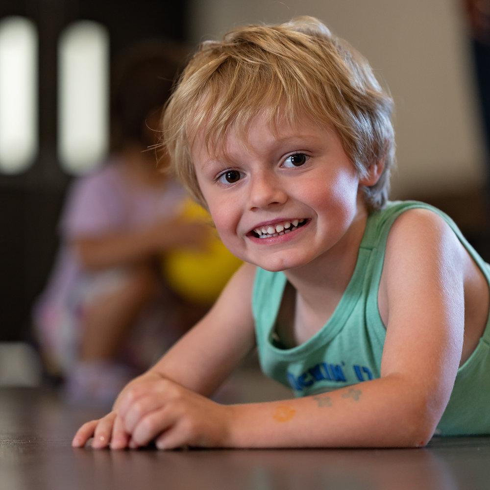 Preschooler smiling on the floor at Victory Academy, a Christian pre-K program in Raleigh NC