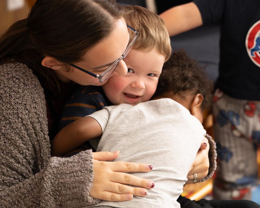 Teacher holding an infant at Victory Academy, a Christian infant daycare in Raleigh NC