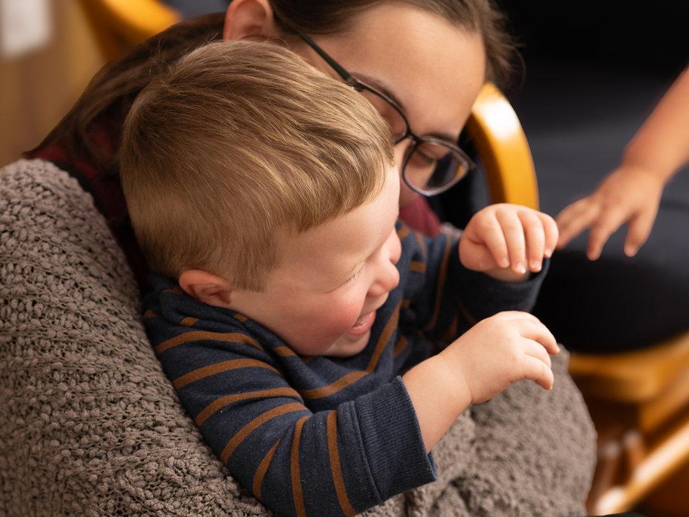 Teacher reading with a toddler at Victory Academy's toddler childcare room in Raleigh